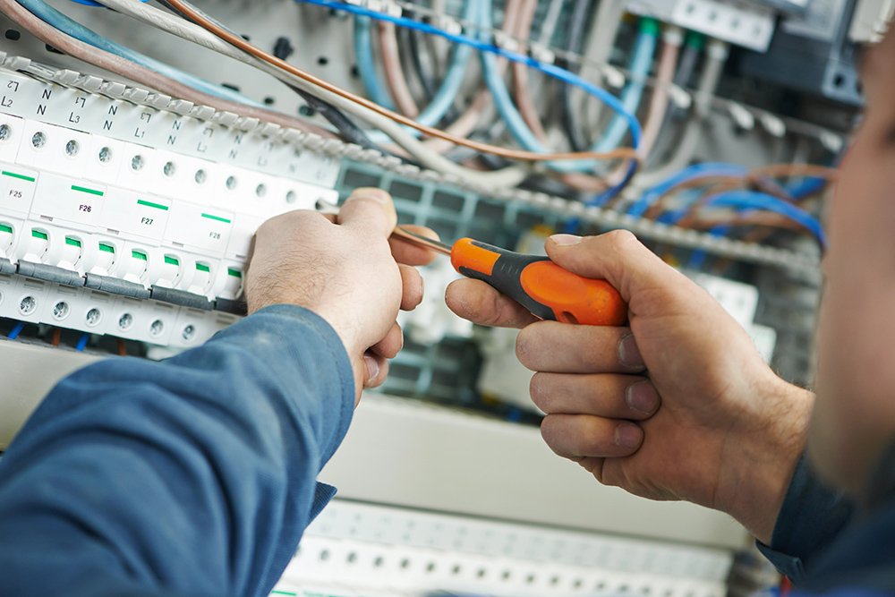 Electrician working on circuit board